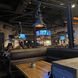 Booth table, antler chandelier and TVs