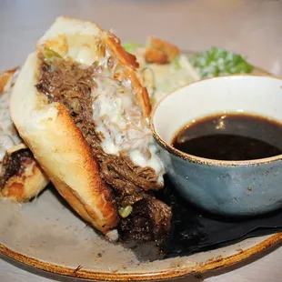 The Grinder is made with Braised Beef, Giardiera, Red Onion, Garlic Aioli, Provolone, &amp; Ajus.