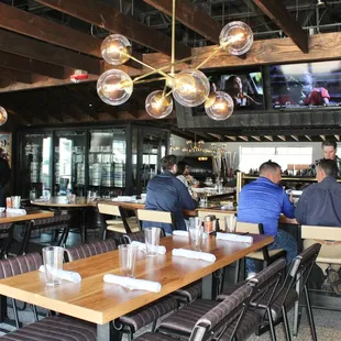 The aesthetic of the restaurant is ski lodge inspired with rustic ski equipment, exposed wood beams, metal light fixtures and warm tones