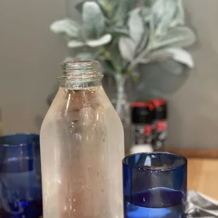  blue glass and a bottle of water