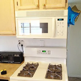 Gleaming stove top and microwave.