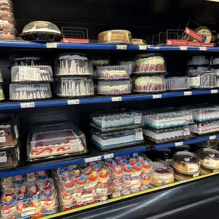 a display of cakes and other desserts