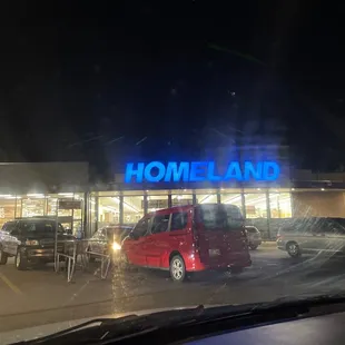 a red van parked in front of a store