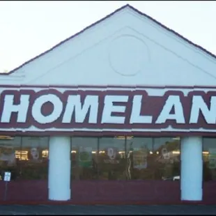 the front of a store with cars parked in front of it