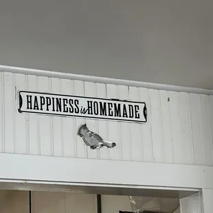 a sign on the wall above a doorway