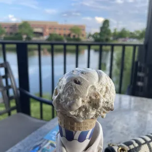 a hand holding a cone of ice cream