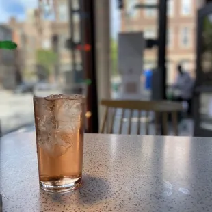 a glass of iced tea on a table