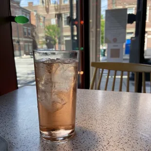 a glass of iced tea on a table