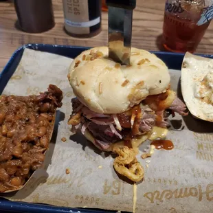 Sammy Sandwich - pulled pork, brisket with queso and fried onions with beans and potato salad