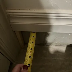 a hand holding a measuring tape