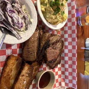 Brisket meal with pork belly, potato salad and coleslaw