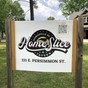 a sign for homeslice tavern