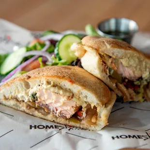 a sandwich with a side salad