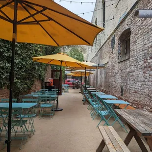 a patio with tables and umbrellas
