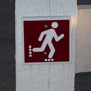 The roller blading sign on one of the fences