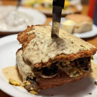 a knife cutting into a sandwich