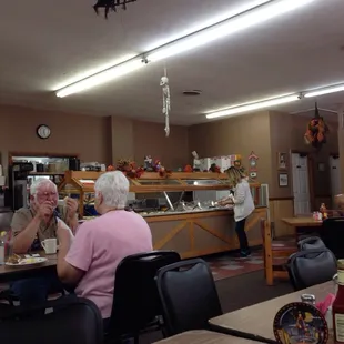 people sitting at a table with plates of food