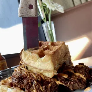 a stack of waffles on a plate with a knife