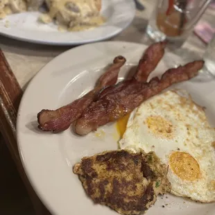 Farmers breakfast with two eggs over easy (or what ever that is) bacon upcharged for  1/2 biscuits and gravy &amp; up charge for crab cake.