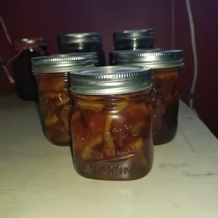 jars of pickled fruit on a countertop