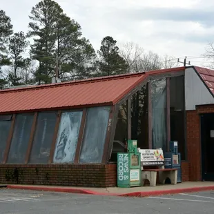 ows a brick building with a red roof