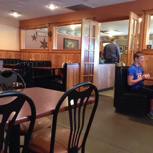 a boy sitting at a table in a restaurant