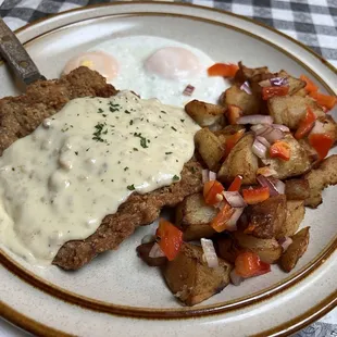 Chicken fried steak, basted eggs, home fries, also pancakes