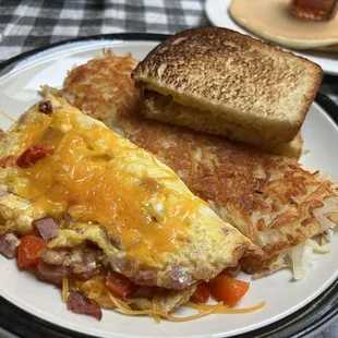 Senior omelette with ham/cheddar/red peppers, hash browns and sour dough toast.