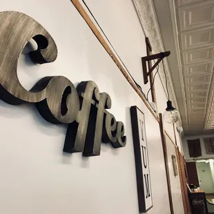 a coffee shop sign on the wall