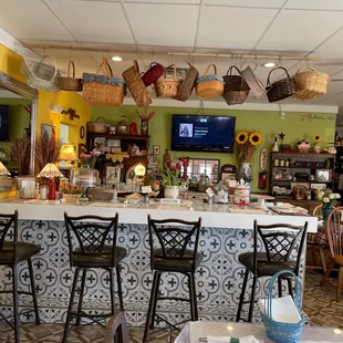 a counter with chairs and a television