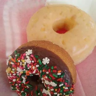 two doughnuts with chocolate frosting and sprinkles