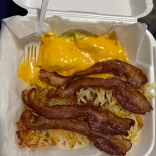 A number 2 Eggs with Meat, 2 Potatoes Pancakes, Toast and Jelly