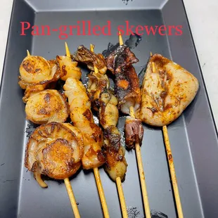 a plate of grilled skewers