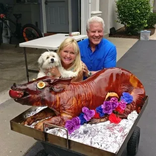 a man and woman with a dog in a wagon