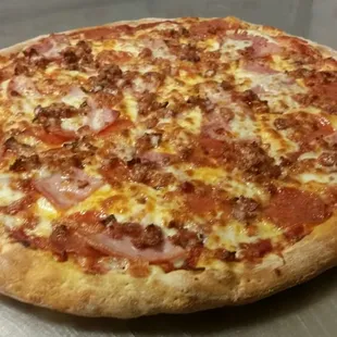 a freshly baked pizza on a metal surface