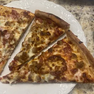 three slices of pizza on a plate