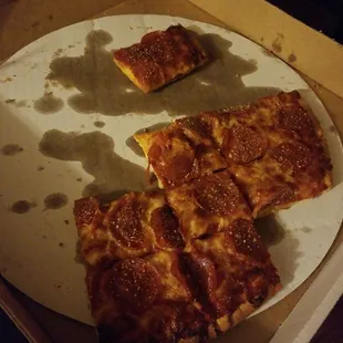 a half eaten pizza in a box