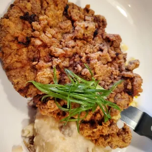 Fried steak, smashed potatoes