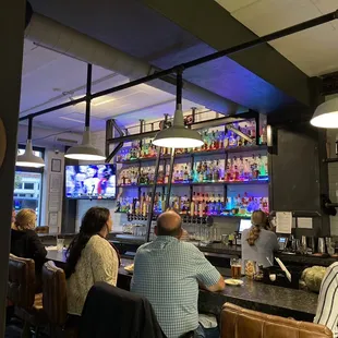 a group of people sitting at a bar