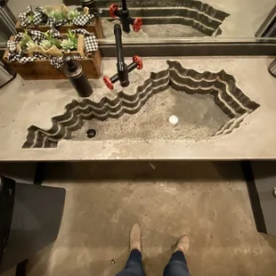 a person standing in front of a sink