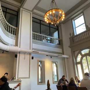 a group of people sitting at a table in a large room