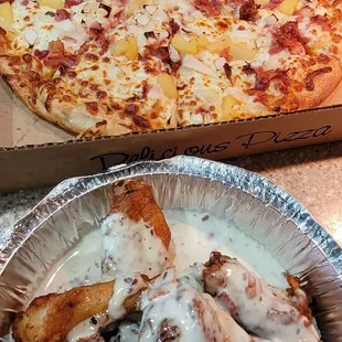 a box of chicken wings and a pizza