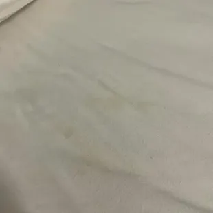 Soiled dirty sheets still wrinkled from previous guest.