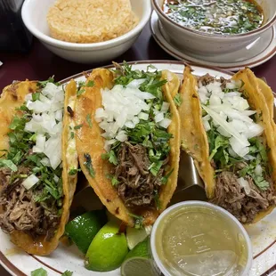 Birria Tacos with a side of rice.
