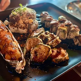 Left: Hawaiian BBQ Salmon Roll, top Dynamite Roll, beneath Las Vegas roll and right Dragon Roll