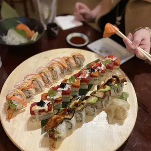 a plate of sushi and chopsticks
