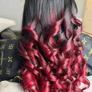 the back of a woman's head with red and black hair