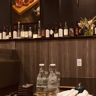 a bar with bottles of wine and meat