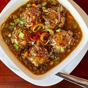 a bowl of stew with meatballs