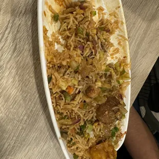 a plate of rice with meat and vegetables